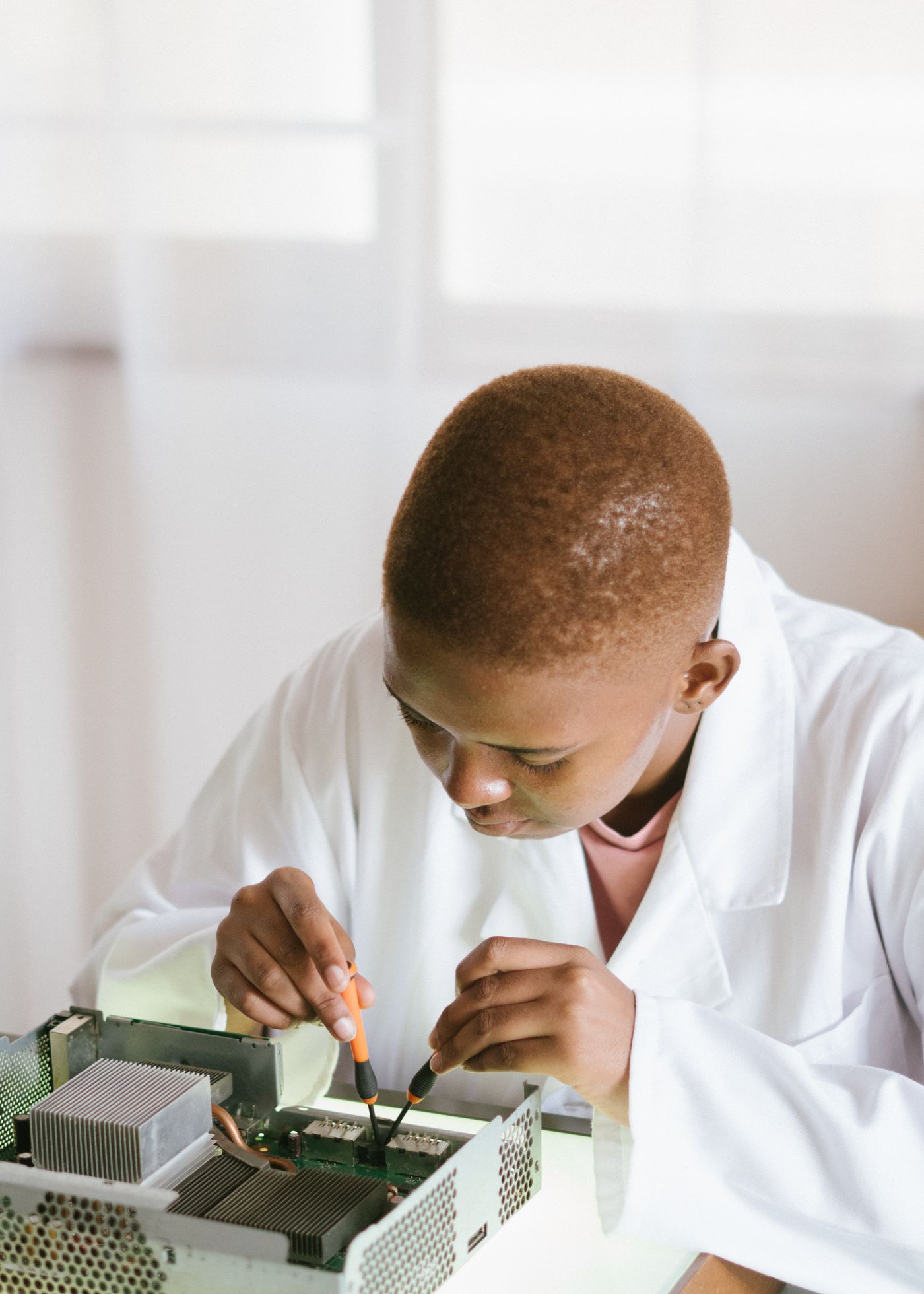 Technician repairing an electronic circuit board