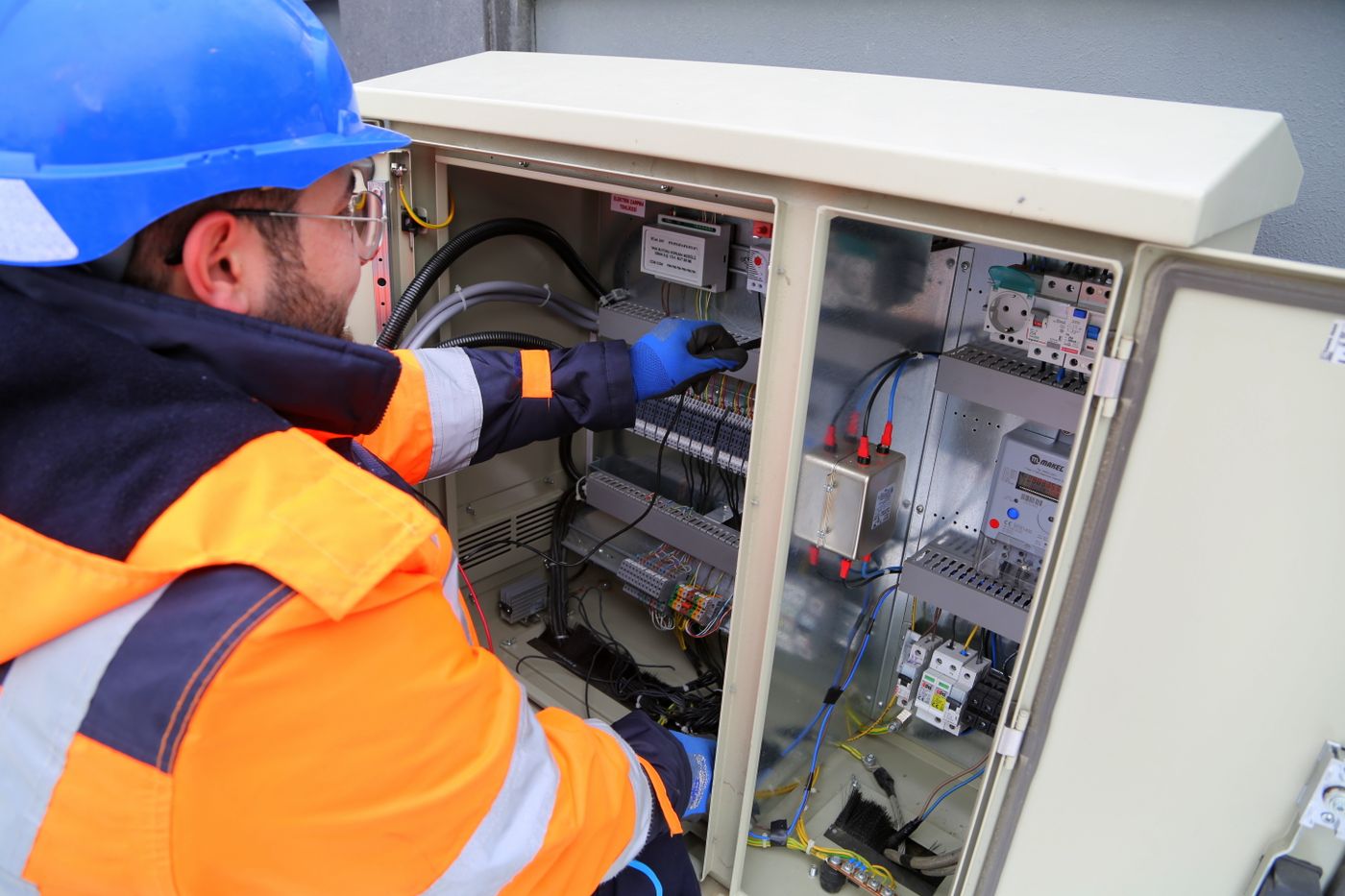 Electrician working on a fuse box