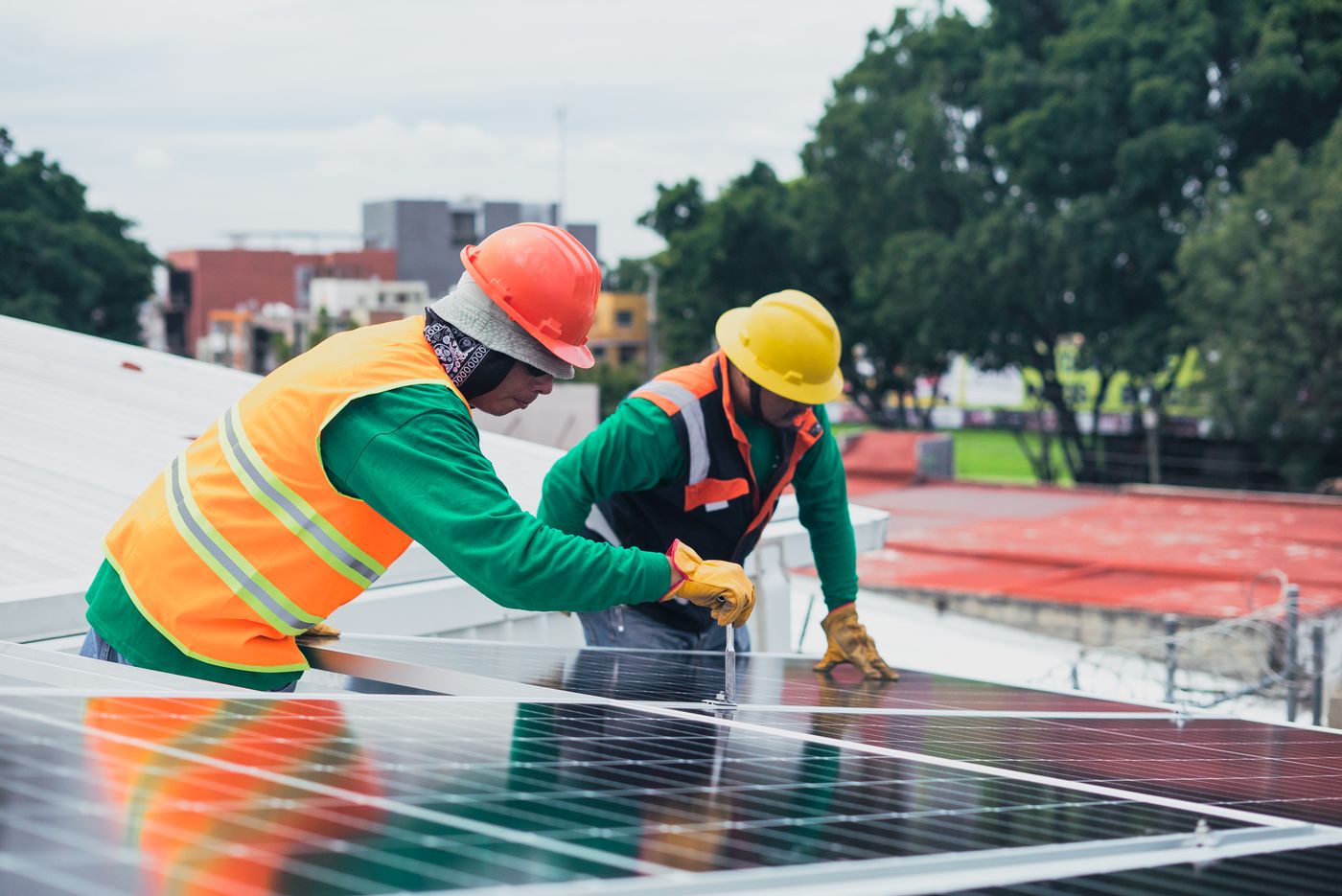 Technicians installing a rooftop solar panel